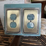 2 Pk Decorative Wall Plates Henne Bery Rope Edge, Aged Bronze Plug Outlet. Fixed Price $18.99.